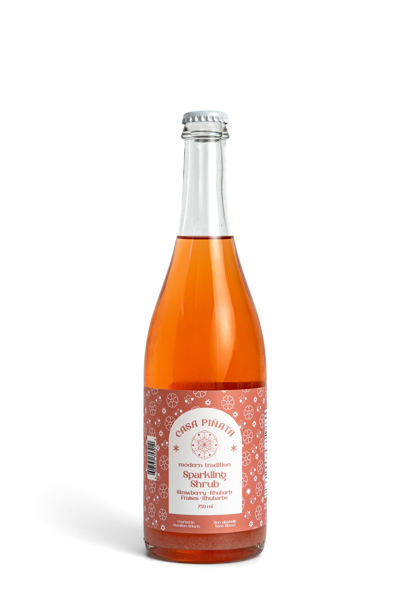 750 ml clear champagne bottle of Casa Piñata Strawberry Shrub against a white background
